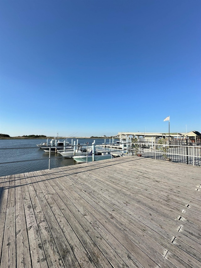 dock area with a water view and boat lift