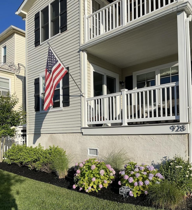 view of side of property with a balcony