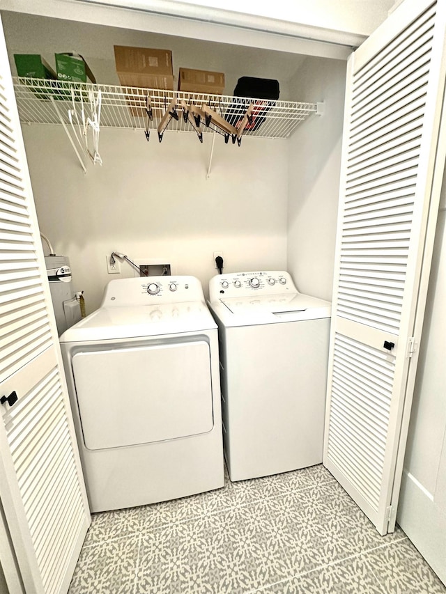 laundry area with separate washer and dryer, light floors, and laundry area