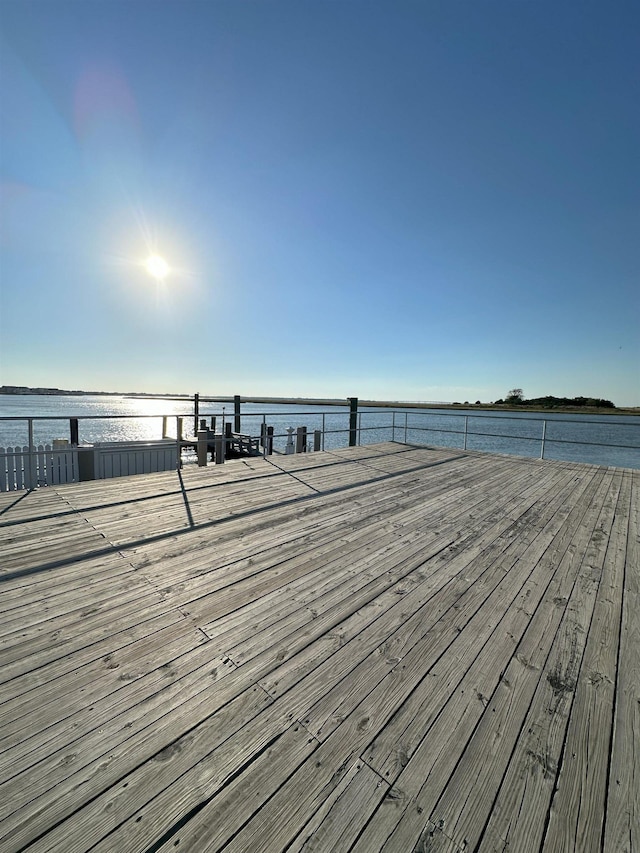 view of dock with a deck with water view