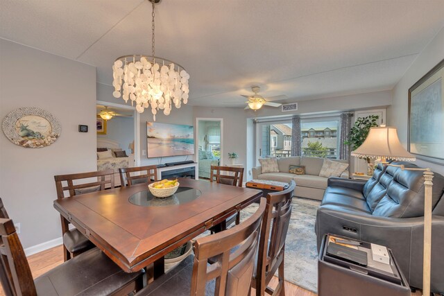 9907 Seapointe Blvd Unit 215, Lower Township, NJ 08260 - dining area featuring ceiling fan, light wood-style flooring, and a chandelier