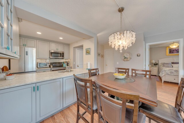 9907 Seapointe Blvd Unit 215, Lower Township, NJ 08260 - dining room with light wood finished floors, a chandelier, and recessed lighting