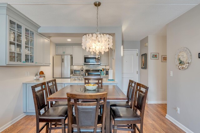 9907 Seapointe Blvd Unit 215, Lower Township, NJ 08260 - dining space with a chandelier and light wood-style flooring