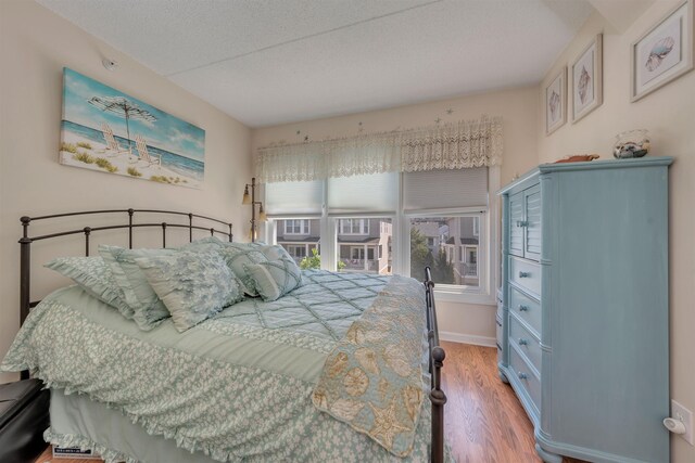 9907 Seapointe Blvd Unit 215, Lower Township, NJ 08260 - bedroom with wood finished floors and a textured ceiling