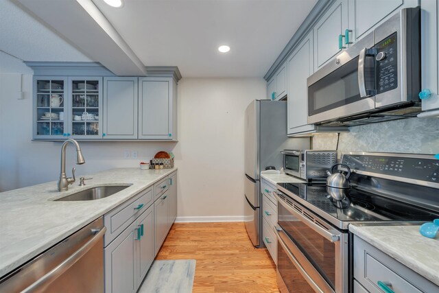 9907 Seapointe Blvd Unit 215, Lower Township, NJ 08260 - kitchen featuring appliances with stainless steel finishes, gray cabinetry, glass insert cabinets, light wood-type flooring, and recessed lighting