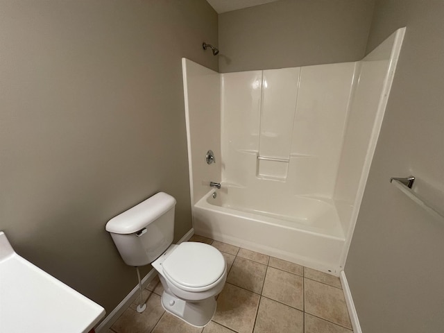 bathroom with tile patterned floors, bathtub / shower combination, and toilet