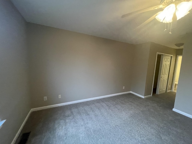 unfurnished room with ceiling fan and dark carpet