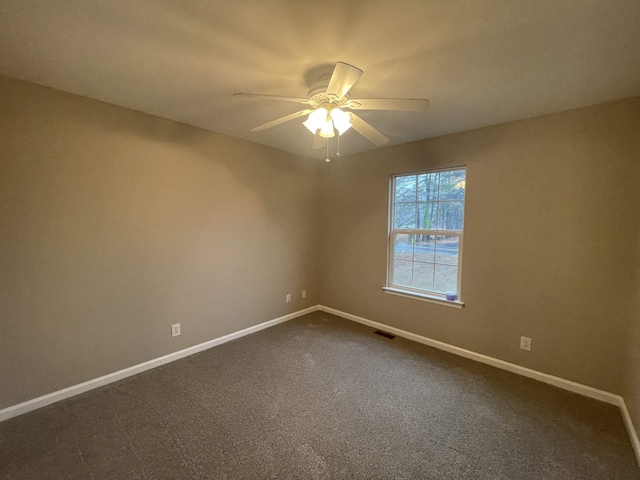 spare room featuring carpet flooring and ceiling fan