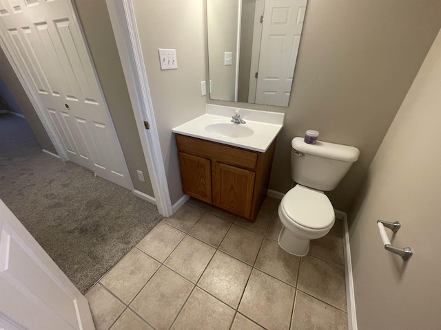 bathroom featuring tile patterned flooring, vanity, and toilet