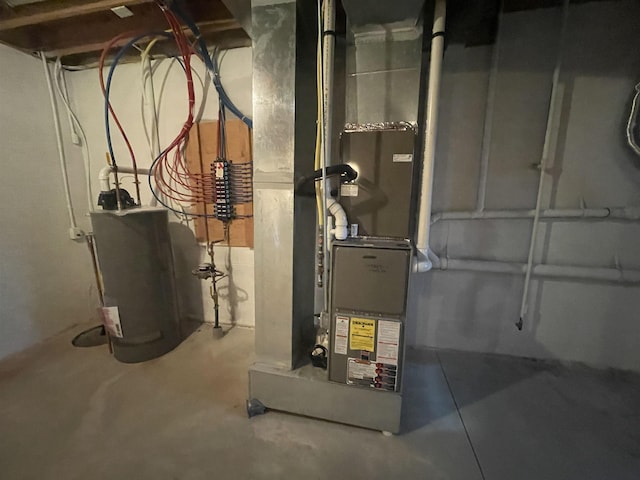 utility room with heating unit and water heater