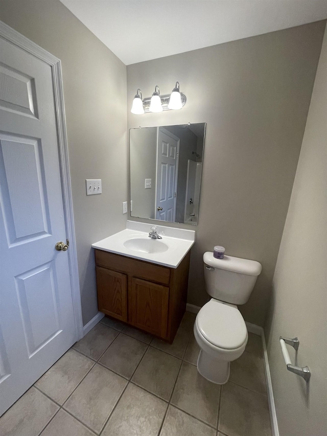 bathroom featuring tile patterned floors, vanity, and toilet