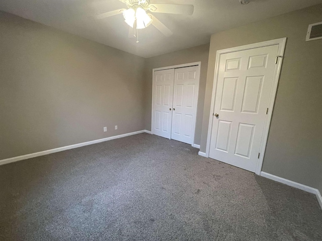 unfurnished bedroom featuring ceiling fan, a closet, and dark colored carpet