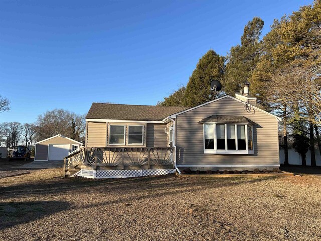 back of property featuring a yard and a wooden deck