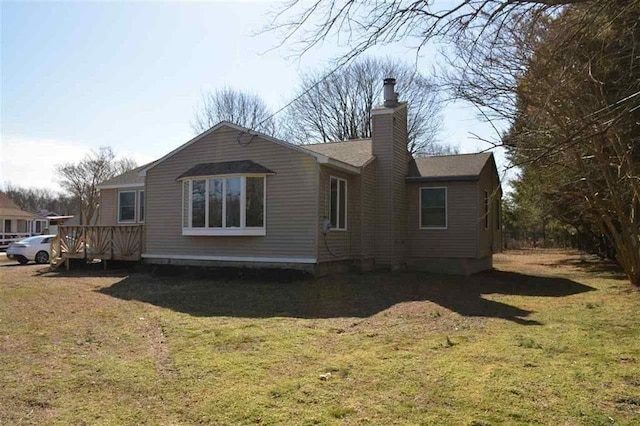 back of house featuring a lawn