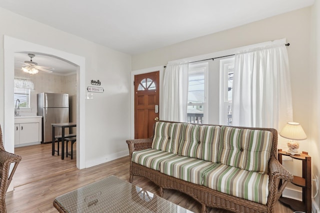 148 E Burk Ave Unit 3, Wildwood, NJ 08260 - living room featuring light wood-style floors, arched walkways, and ceiling fan