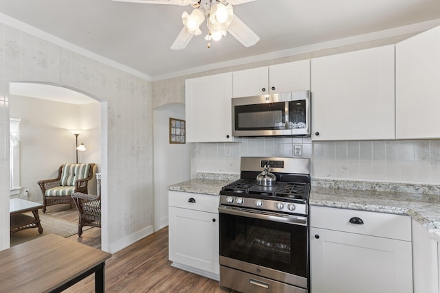 148 E Burk Ave Unit 3, Wildwood, NJ 08260 - kitchen featuring appliances with stainless steel finishes, arched walkways, ceiling fan, wood finished floors, and white cabinetry