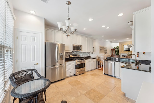 7 Herron Ct Unit 40, Cape May Court House, NJ 08210 - kitchen with appliances with stainless steel finishes, a sink, a chandelier, decorative backsplash, and hanging light fixtures
