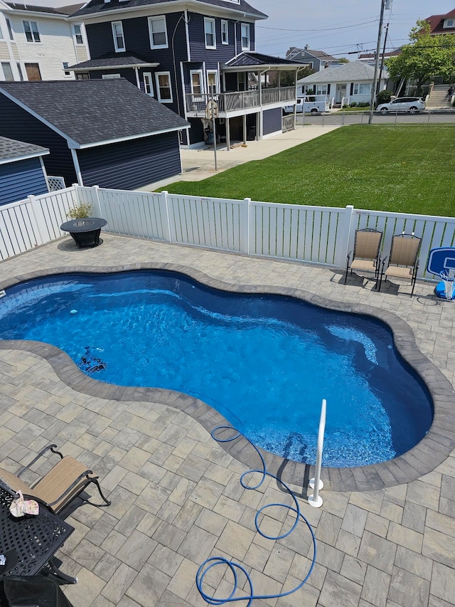view of pool with a fenced backyard, a patio area, a fenced in pool, and a lawn