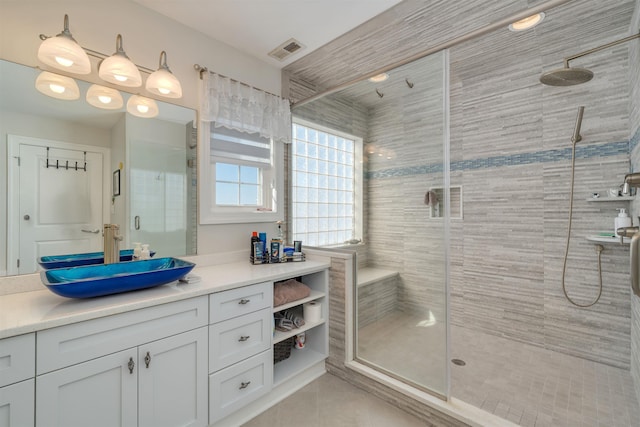 full bath featuring tile patterned floors, visible vents, vanity, and a stall shower