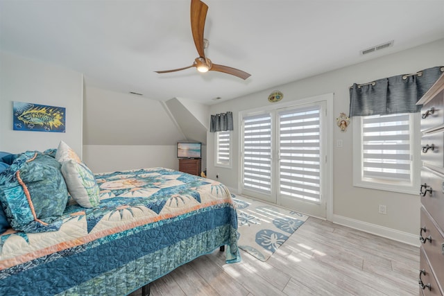 bedroom featuring wood finished floors, visible vents, a ceiling fan, and access to exterior
