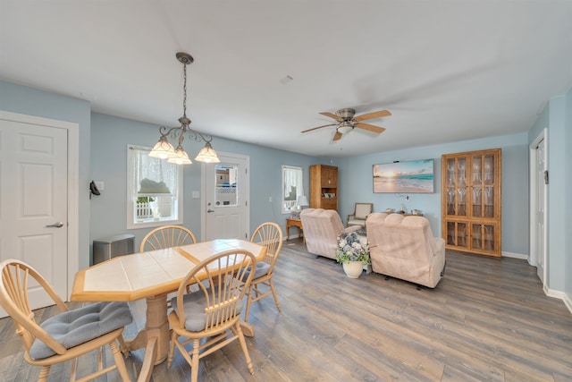 dining room with wood finished floors, baseboards, and ceiling fan