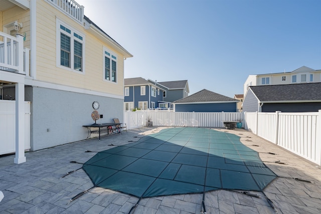 view of pool featuring a residential view, a fenced in pool, a fenced backyard, and a patio