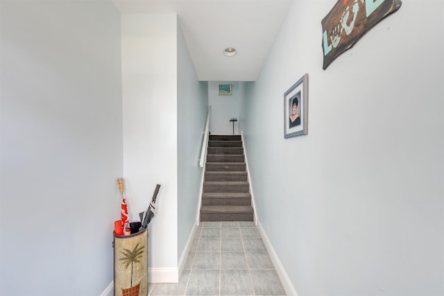 stairs with tile patterned flooring and baseboards