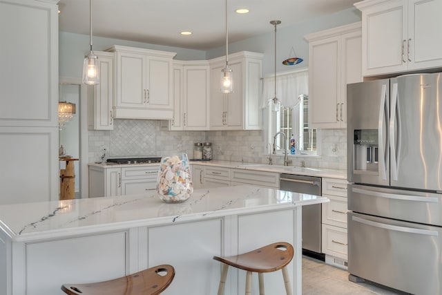 kitchen featuring custom exhaust hood, a sink, stainless steel appliances, backsplash, and light stone countertops