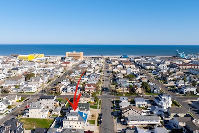 birds eye view of property featuring a water view and a residential view