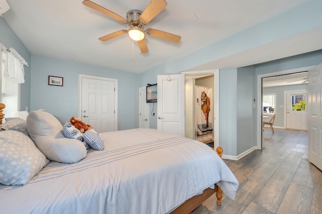 bedroom featuring wood finished floors, a ceiling fan, and baseboards