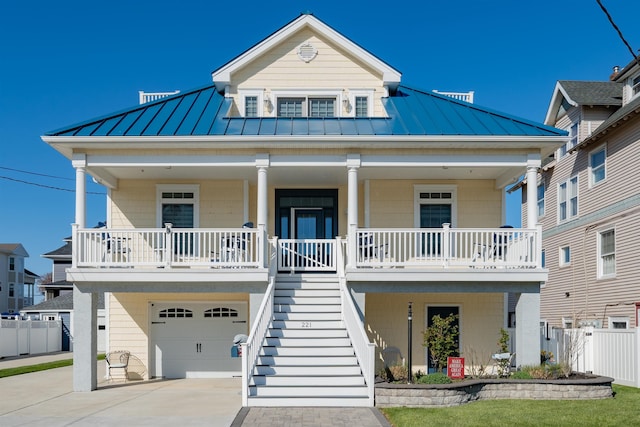 beach home with covered porch, a standing seam roof, and metal roof