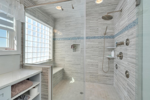 full bath with plenty of natural light and tiled shower