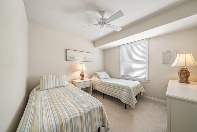 bedroom with light carpet, ceiling fan, and baseboards