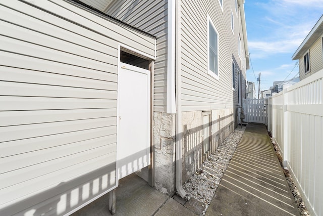 view of side of property featuring fence