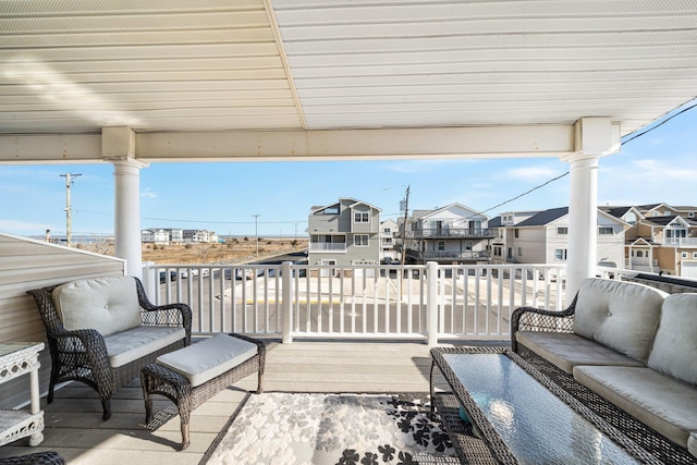 wooden terrace featuring a residential view and an outdoor hangout area