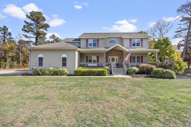 view of front of home with a porch and a front lawn