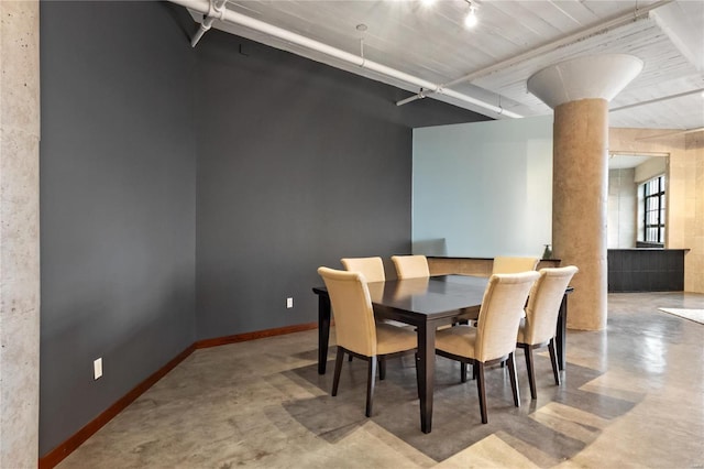 dining area with concrete flooring