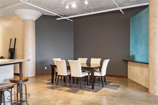 dining space featuring decorative columns