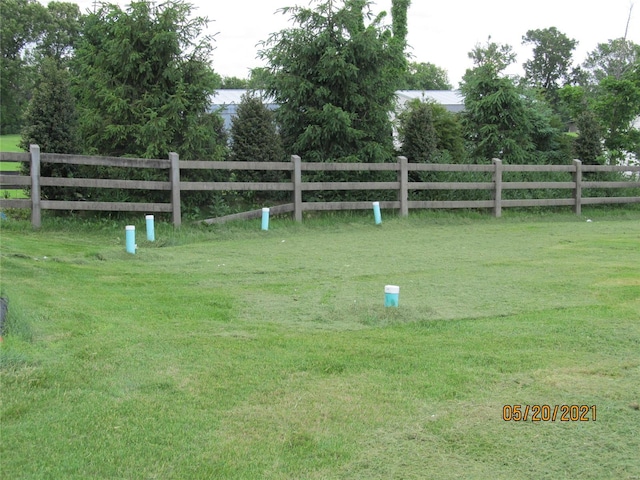 surrounding community with a yard and a rural view