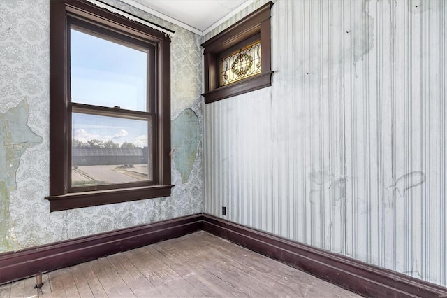 unfurnished room featuring hardwood / wood-style flooring and ornamental molding