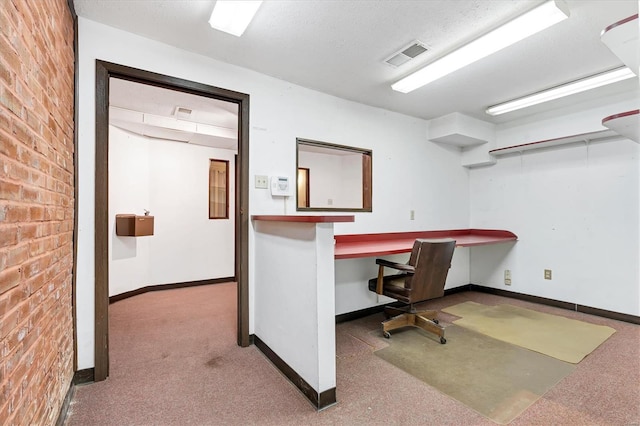 unfurnished office with built in desk and carpet