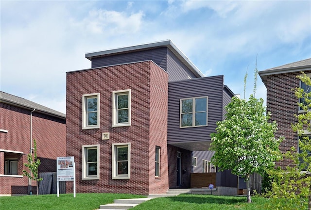 rear view of property with a lawn