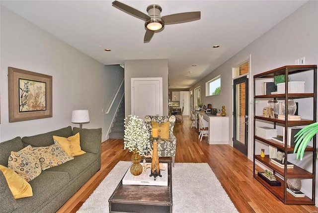 living room featuring hardwood / wood-style floors and ceiling fan