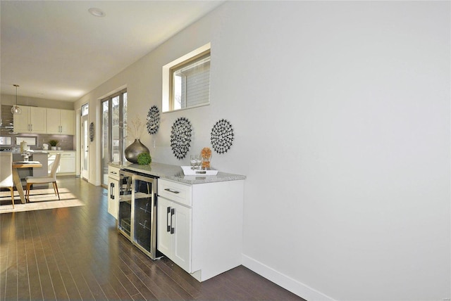 corridor with dark hardwood / wood-style floors and wine cooler