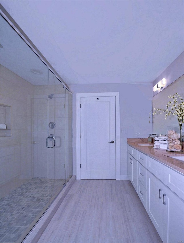 bathroom with walk in shower and vanity