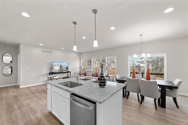 kitchen with white cabinets, light hardwood / wood-style flooring, dishwasher, and sink