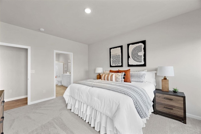 carpeted bedroom featuring ensuite bath