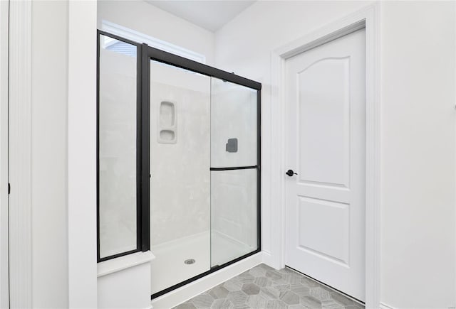 bathroom with walk in shower and tile flooring