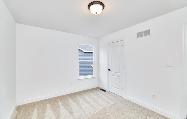 empty room featuring light colored carpet