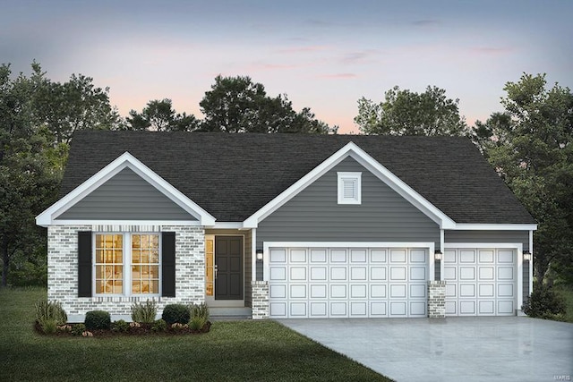 view of front of home with a lawn and a garage